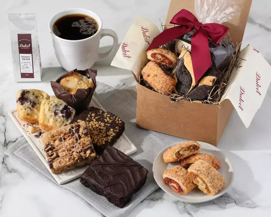Assorted cookies in a box with a red ribbon, coffee,  muffins, cookies  Assorted cookies in a box with a red ribbon, coffee,  muffins, cookies