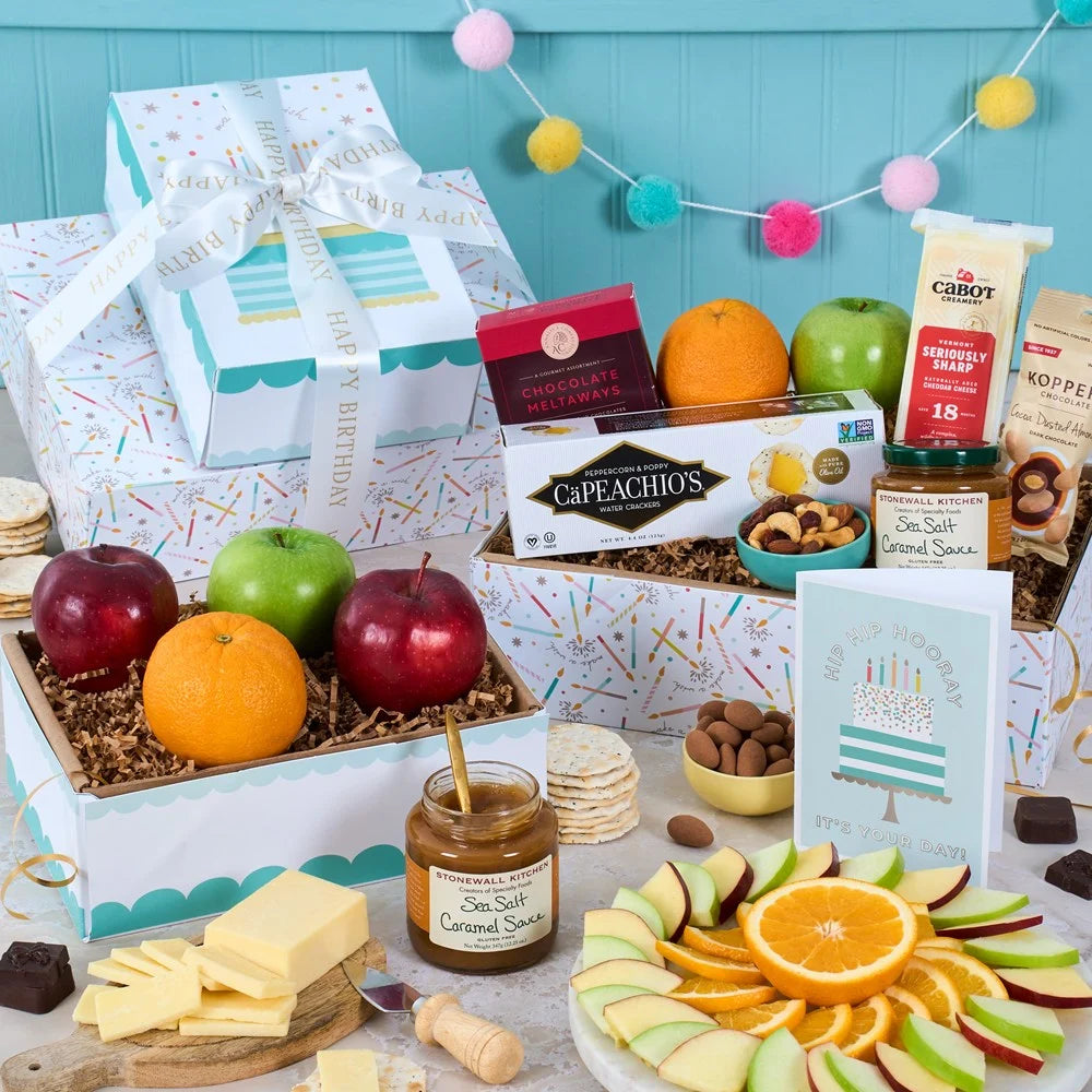 Gourmet gift box with fruits, cheeses, and snacks