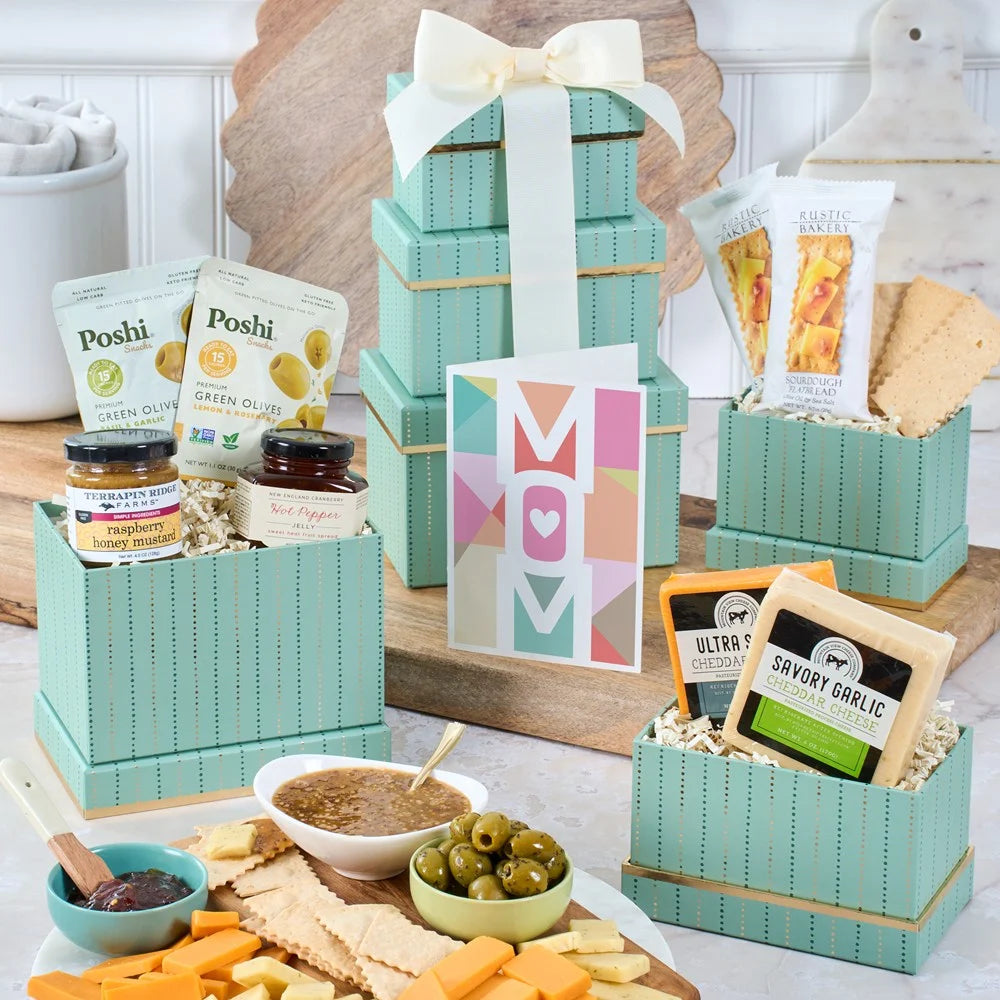 Gift basket with snacks and a 'Mom' card on a table.