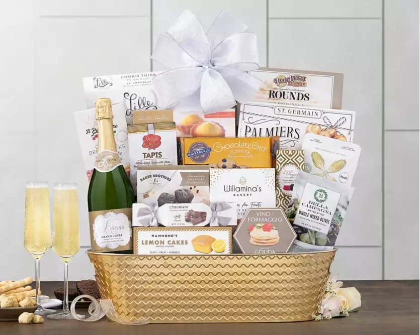 Gift basket with various items including a bottle of Kiarna champagne and snacks