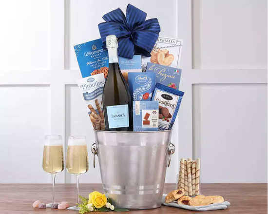 Stainless steel ice bucket with champagne, snacks, and a blue bow   Stainless steel ice bucket with champagne, snacks, and a blue bow