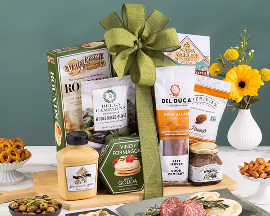 Gift basket with Del Luca products, cheese, and snacks on a cutting board   Gift basket with Del Luca products, cheese, and snacks on a cutting board