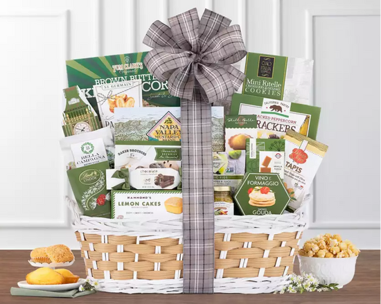 Wicker gift basket with various products including snacks, cakes, cookies,crackers and chocolate Wicker gift basket with various products including snacks, cakes, cookies,crackers and chocolate