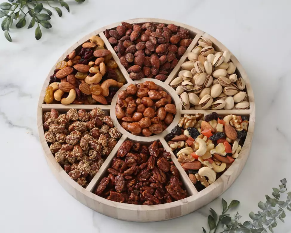 Round wooden tray Kosher with compartments filled with various nuts and fruit mix