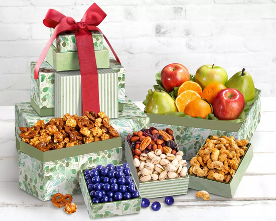 Gift tower with snacks, fruits, and a red ribbon  Gift tower with snacks, fruits, and a red ribbon