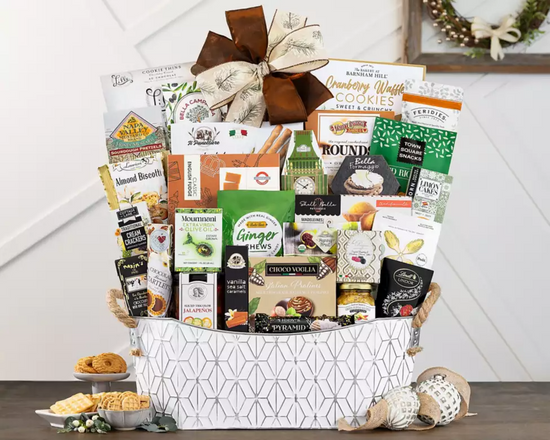 White metal Gift basket filled with various food items on a wooden surface. White metal Gift basket filled with various food items on a wooden surface.