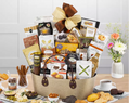 Large gourmet gift basket with various food items in a beige fabric container