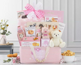 Pink gift basket with teddy bear, snacks, cokies