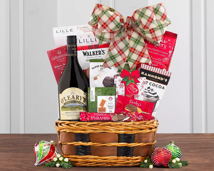 Gift basket with a bottle of alcohol, snacks, and a plaid bow