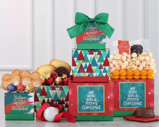 Stack of Christmas-themed gift boxes with festive snacks