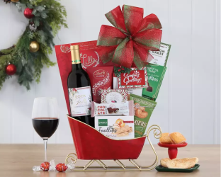 Gift basket sleigh with wine, snacks, and a bottle of red wine