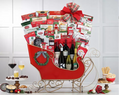 Gift basket in the shape of a sleigh with wine, snacks, and other items 