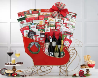 Gift basket in the shape of a sleigh with wine, snacks, and other items 