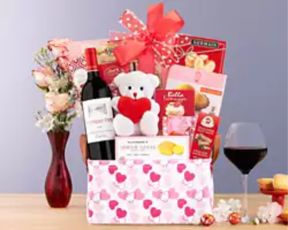 Gift basket with wine, teddy bear, and snacks for Valentine’s Day 