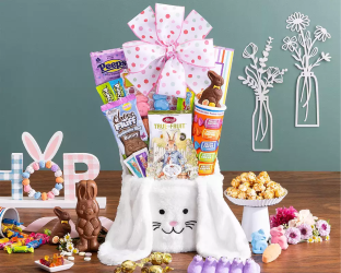 Easter gift basket with bunny ears, candy, and decorative items