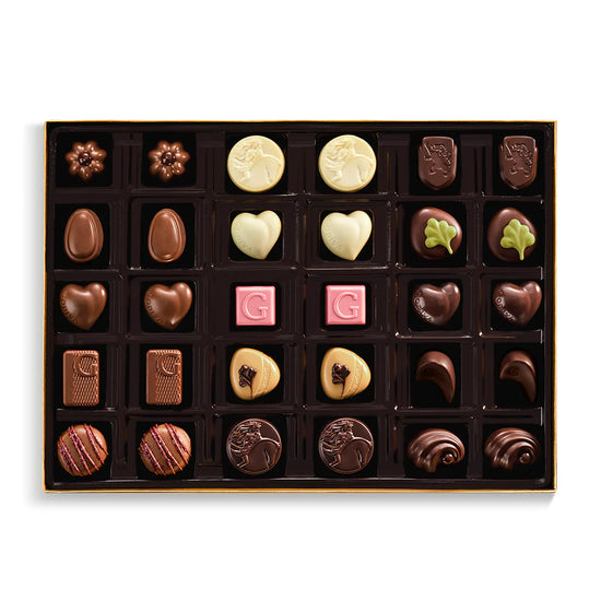 Assorted chocolates in a decorative box on a white background