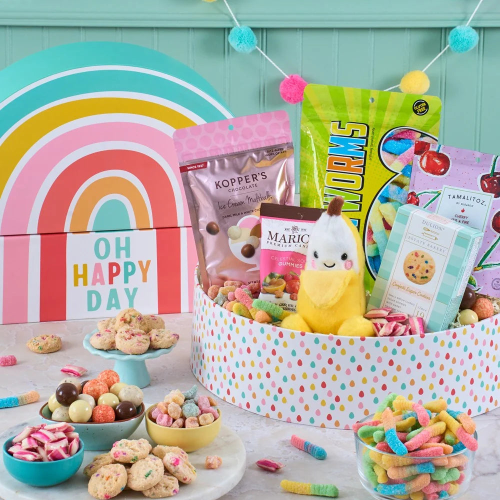 Assorted snacks and candies in a colorful box with 'Oh Happy Day' branding