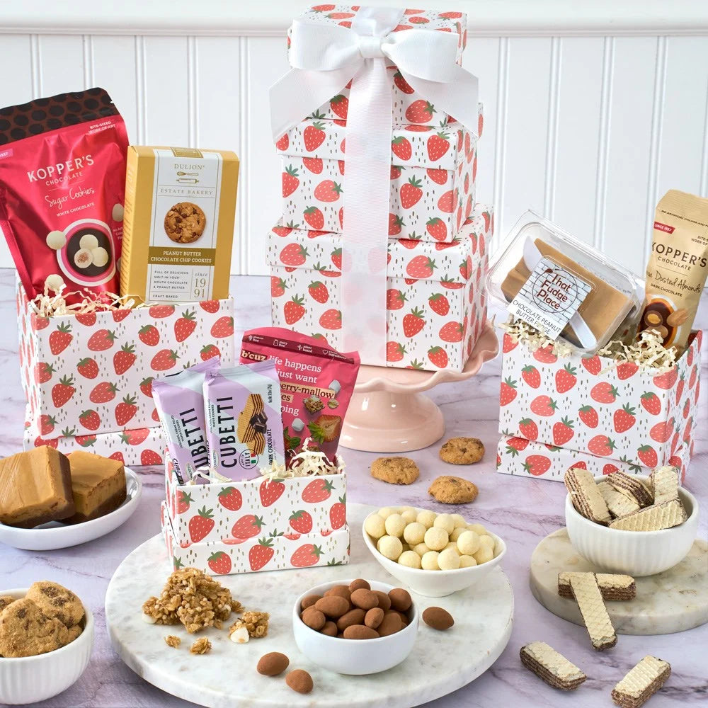Assorted snacks and treats on a table with strawberry-patterned packaging.