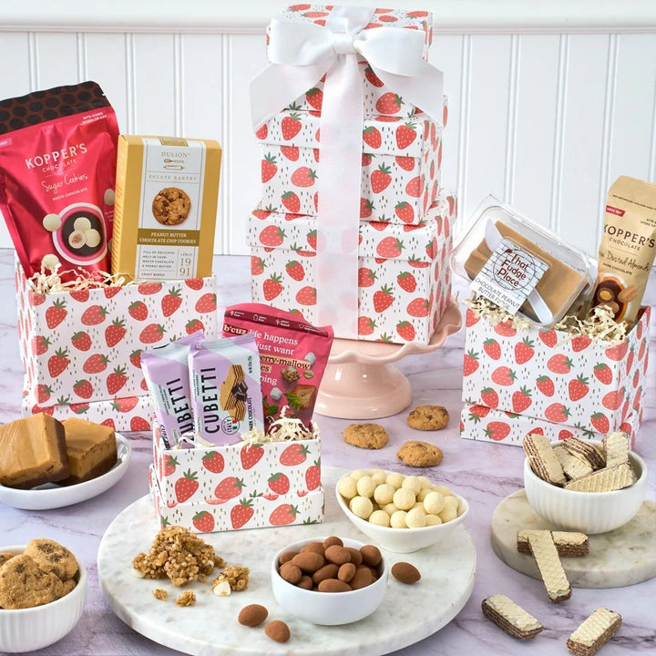 Assorted snacks and treats on a table with strawberry-patterned packaging.