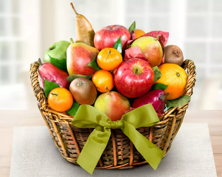 Wicker basket of assorted organic fruits with including apples, oranges, tangerines, kiwis and pears
