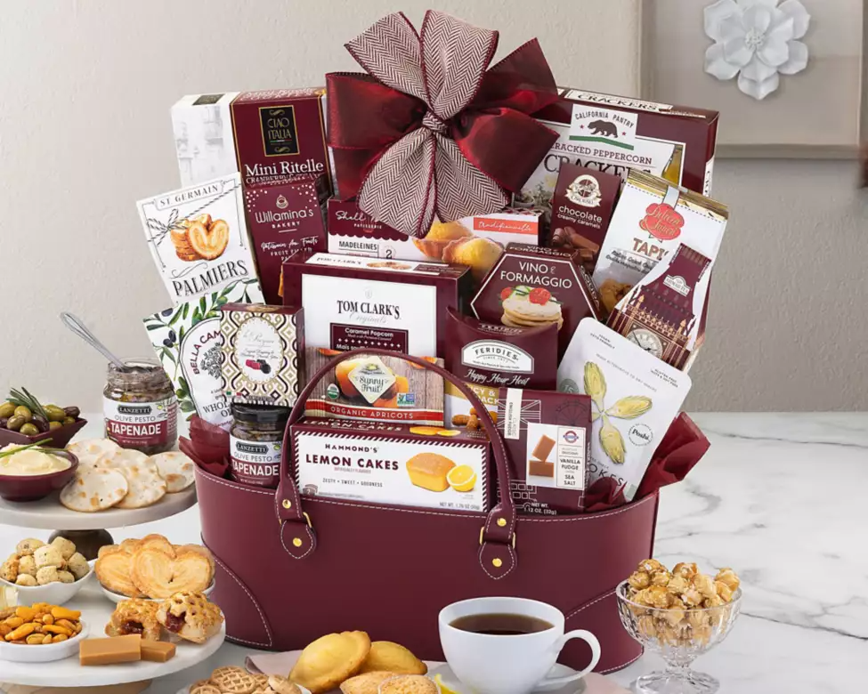 Gourmet gift basket with various food items in a leather container