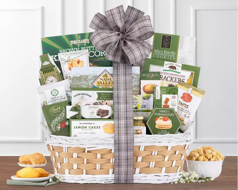 Wicker gift basket with various products including snacks, cakes, cookies,crackers and chocolate